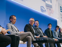 Ernste Gesichter bei den Podiumsteilnehmenden während der intensiven Diskussion